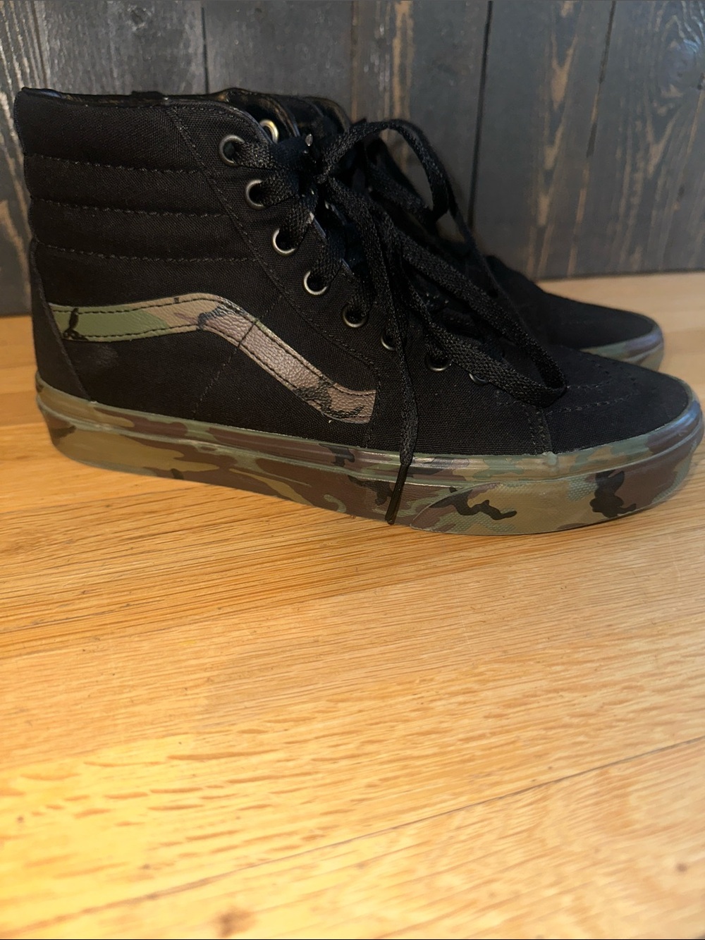 Vans Camo High-Top Sneakers with Camouflage Sole and Black leather Upper.